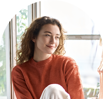 Woman sitting by window smiling